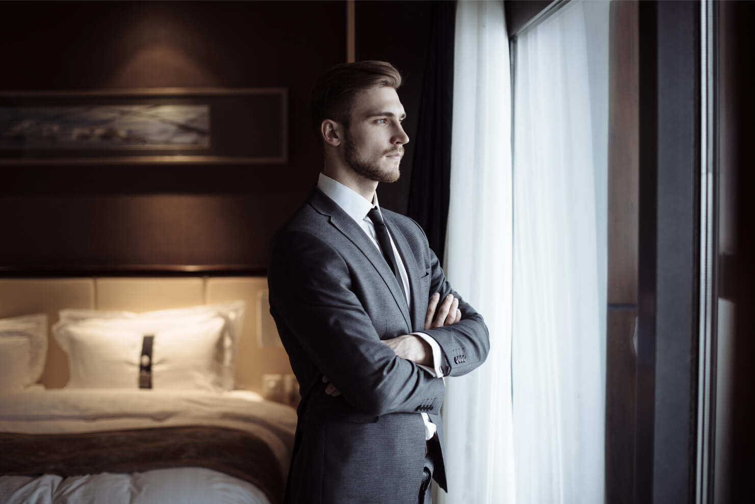 Man looking out window